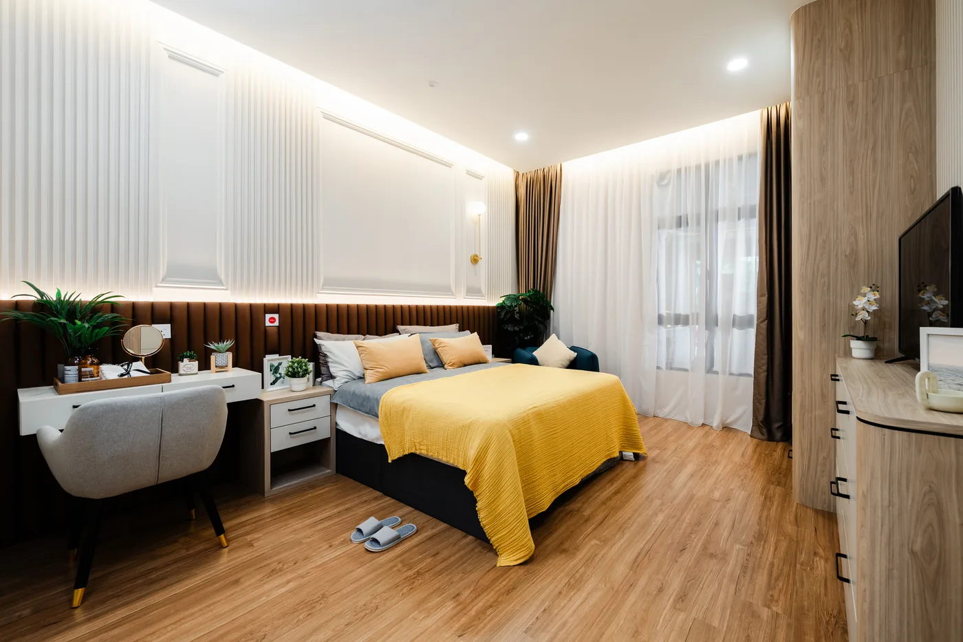 Furnished bedroom with dressing table and TV console